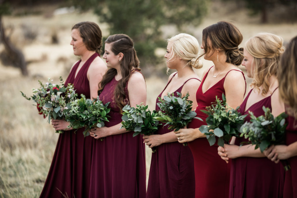Bridesmaids carrying greenery bouquets using no flowers