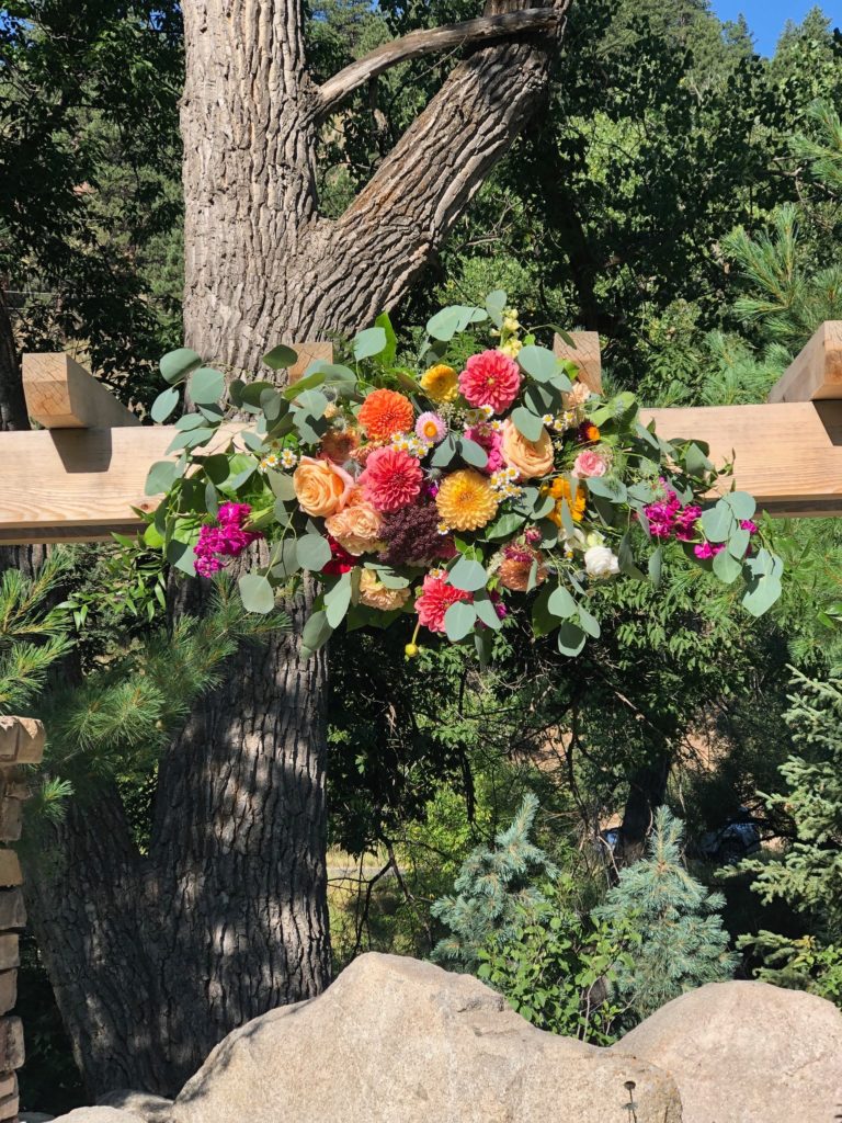 Vibrant arch piece using seasonal flowers
